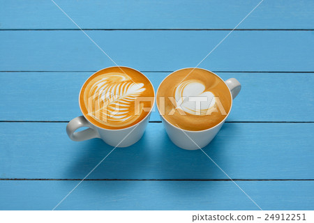Latte Art, cups of cafe latte on wooden background 24912251