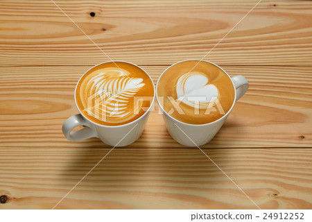 Latte Art, cups of cafe latte on wooden background 24912252