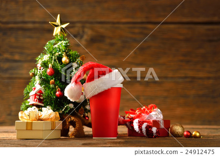 Paper coffee cup with Santa's hat on top 24912475