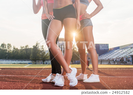 Beautiful legs of three athlete fit women at Beautiful legs of three athlete fit women at 24912582