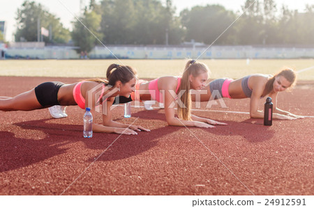 Athletic group of women training on a sunny day Athletic group of women training on a sunny day 24912591
