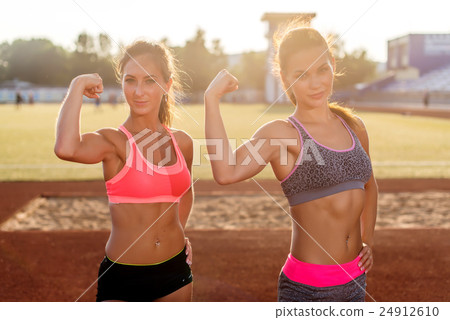 Sporty young women with perfect bodies showing Sporty young women with perfect bodies showing 24912610