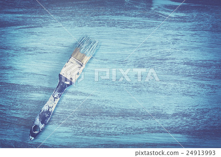 Vintage toned dirty paintbrush with blue paint. Vintage toned dirty paintbrush with blue paint. 24913993