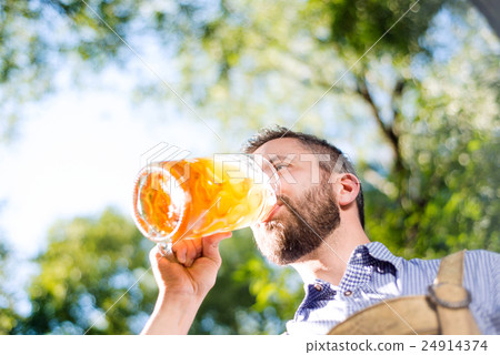 Man in traditional bavarian clothes holding mug of Man in traditional bavarian clothes holding mug of 24914374