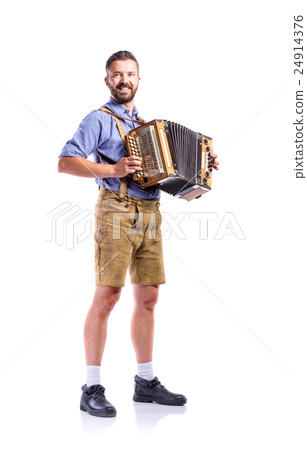Man in traditional bavarian clothes playing Man in traditional bavarian clothes playing 24914376