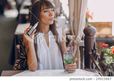 girn in cafe with E-Cigarette 24915667