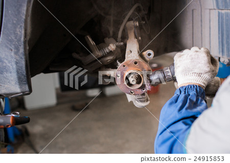 Brand new brake disc on car in a garage. Auto 24915853