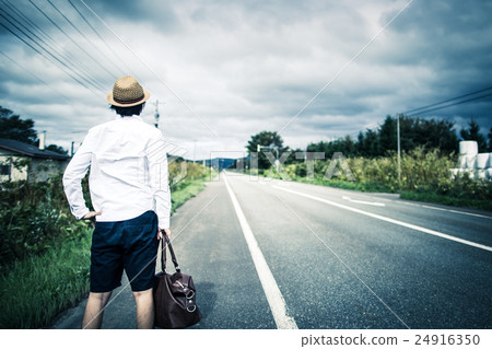 A man walking on a straight road 24916350