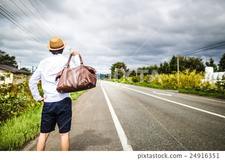 A man walking on a straight road 24916351