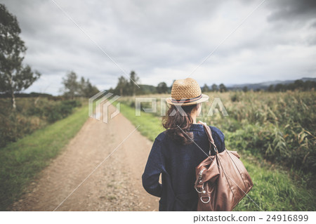 A woman walking on a natural path 24916899