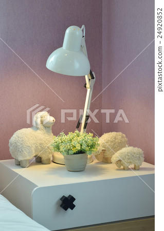 Cozy bedroom with reading lamp on white table 24920852