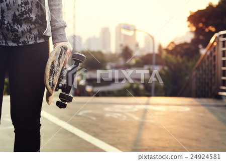 Skater Boy Holding Skateboard Outdoors Concept 24924581