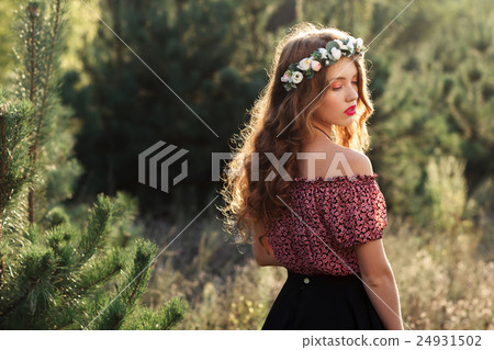 Beautiful girl standing in forest half-turned Beautiful girl standing in forest half-turned 24931502