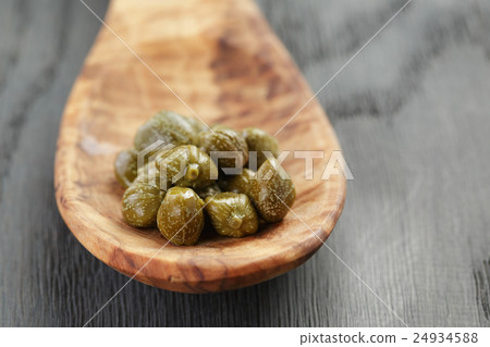 marinated capers in wood spoon on table marinated capers in wood spoon on table 24934588
