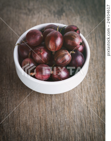 gooseberries in a bowl on a wood background 24934617