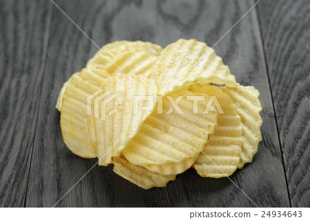 rippled organic chips on wooden table 24934643