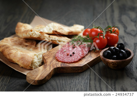 Antipasti with salami, olives, tomatoes and bread Antipasti with salami, olives, tomatoes and bread 24934737
