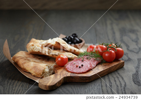 Antipasti with salami, olives, tomatoes and bread 24934739