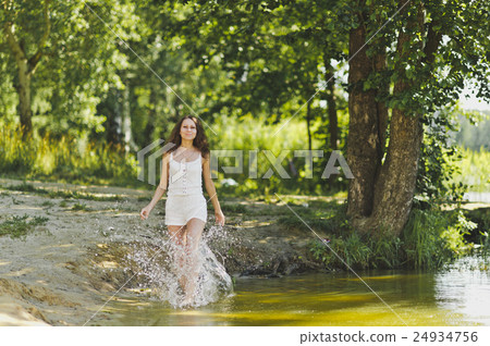 Portrait of a girl walking on the water the lake Portrait of a girl walking on the water the lake 24934756