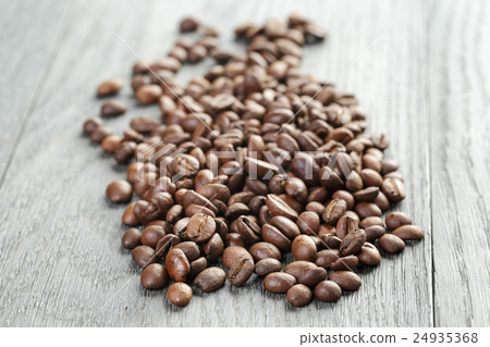 freshly roasted coffee beans on wooden table 24935368