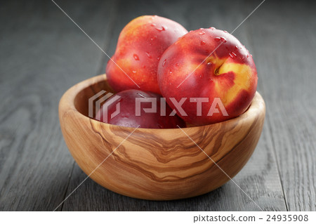 nectarines in olive wood bowl on oak table nectarines in olive wood bowl on oak table 24935908