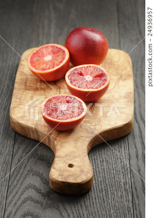 red sicilian oranges sliced on olive board red sicilian oranges sliced on olive board 24936957