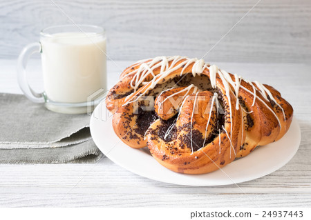 Glass of milk and sweet roll Glass of milk and sweet roll 24937443