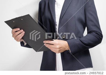 Businesswoman holding a clipboard 24937812