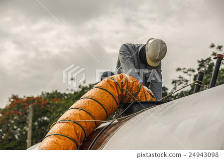 Worker blow fresh air into vessel 24943098