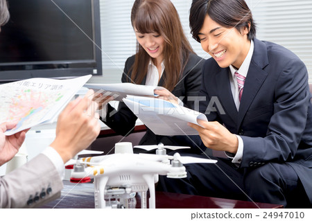 Male employee female employee drone introduction review company unmanned aerial vehicle radio control pilot aircraft quad copter 24947010