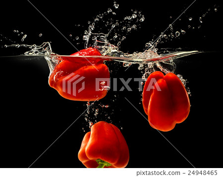 Group of bell pepper falling in water on black Group of bell pepper falling in water on black 24948465