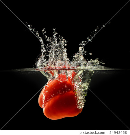 Red bell pepper falling in water on black Red bell pepper falling in water on black 24948468