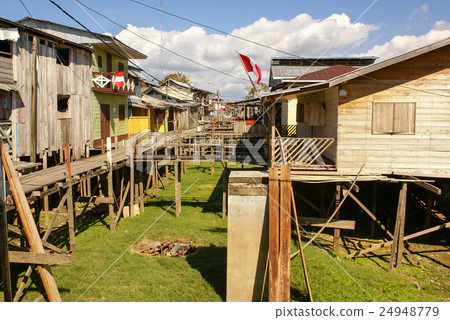 Houses on stilts rise above the polluted water Houses on stilts rise above the polluted water 24948779