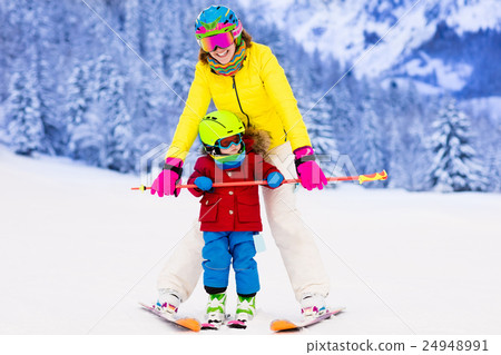 Mother and little boy learning to ski 24948991