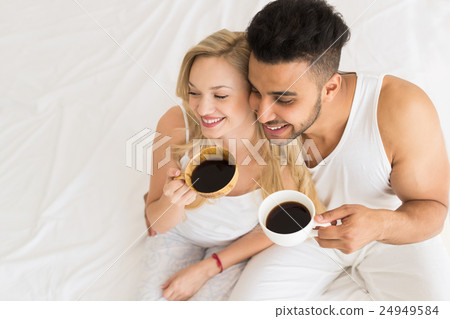 Young Couple Drink Coffee Sitting In Bed, Happy 24949584
