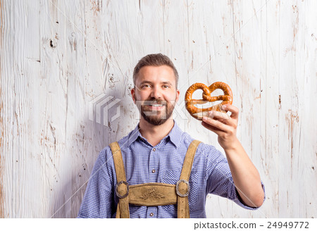 Man in traditional bavarian clothes holding Man in traditional bavarian clothes holding 24949772