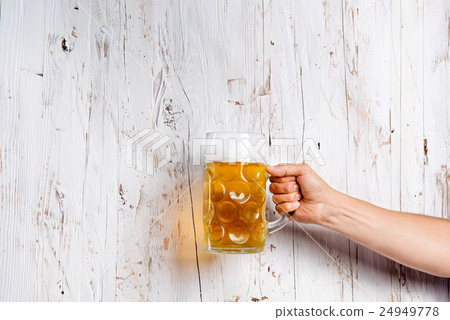 Unrecognizable man holding a beer mug, studio shot Unrecognizable man holding a beer mug, studio shot 24949778