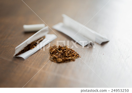 close up of marijuana or tobacco cigarette paper 24953250