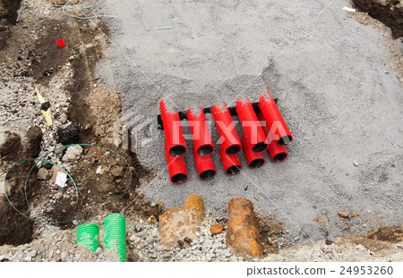 close up of pipes sticking out ground 24953260