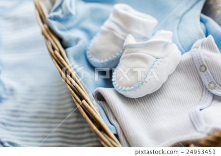 close up of baby clothes for newborn boy in basket 24953451