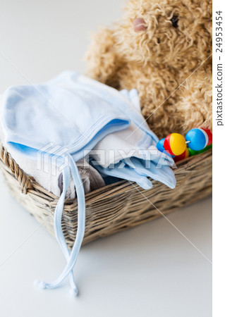 close up of baby clothes and toys for newborn 24953454