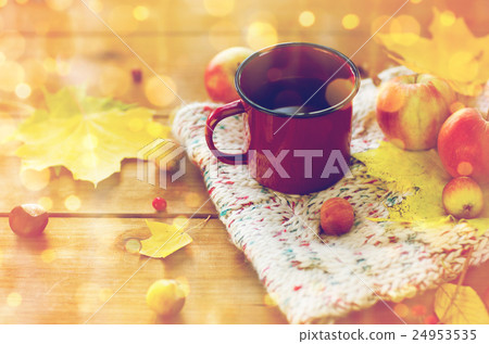 close up of tea cup on table with autumn leaves 24953535