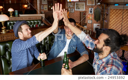men with beer making high five at bar or pub 24953892