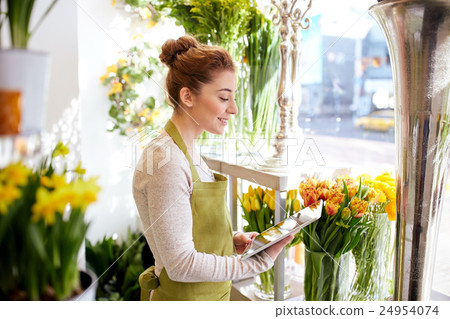 woman with tablet pc computer at flower shop woman with tablet pc computer at flower shop 24954074