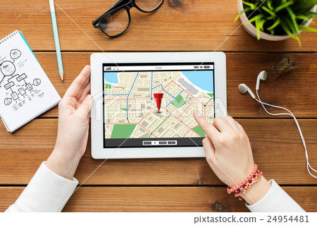 close up of woman with tablet pc on wooden table close up of woman with tablet pc on wooden table 24954481