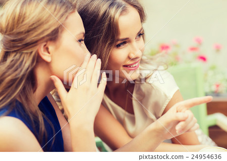 smiling young women gossiping at outdoor cafe smiling young women gossiping at outdoor cafe 24954636