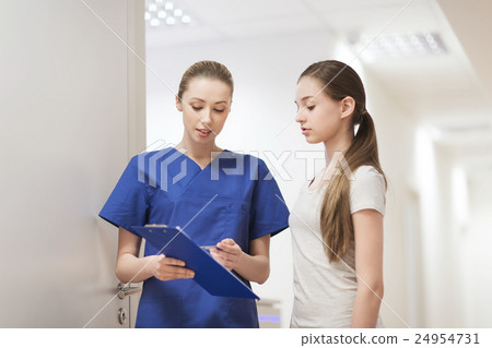 doctor or nurse with clipboard and girl patient doctor or nurse with clipboard and girl patient 24954731