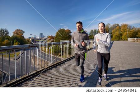 happy couple running outdoors happy couple running outdoors 24954841