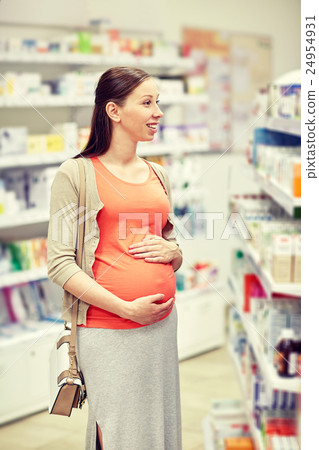 happy pregnant woman choosing medicine at pharmacy 24954931