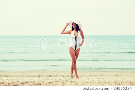 young woman in swimsuit posing on beach young woman in swimsuit posing on beach 24955284